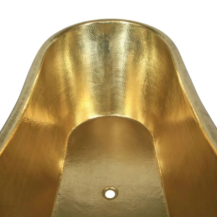 Artisan handmade brass bathtub with golden shine and curved slipper edges in bathroom setting
