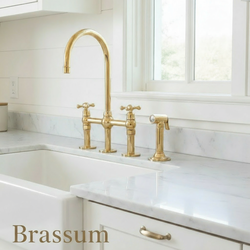 Kitchen with a white sink and gold faucet
