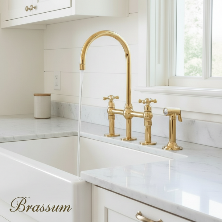 Kitchen with white cabinets, marble countertop, and gold faucet.
