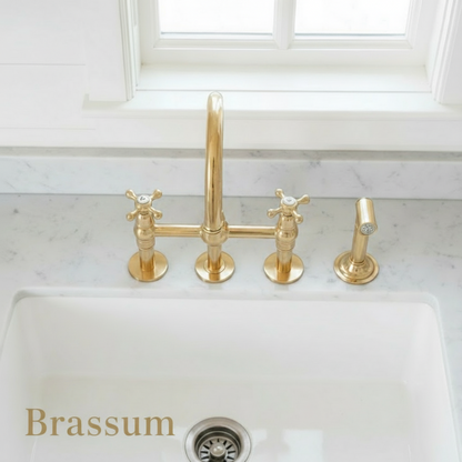 Gold faucet on a white kitchen sink